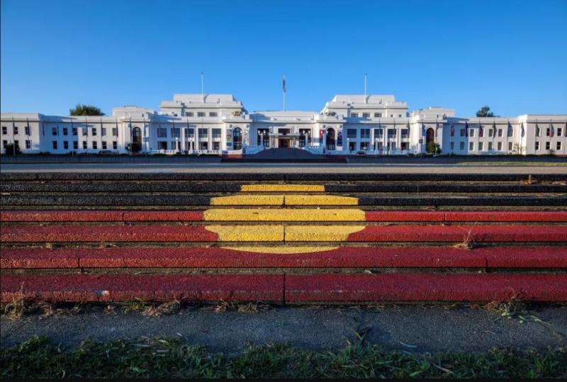 Aboriginal Flag covering the steps with Old Parliament House in background