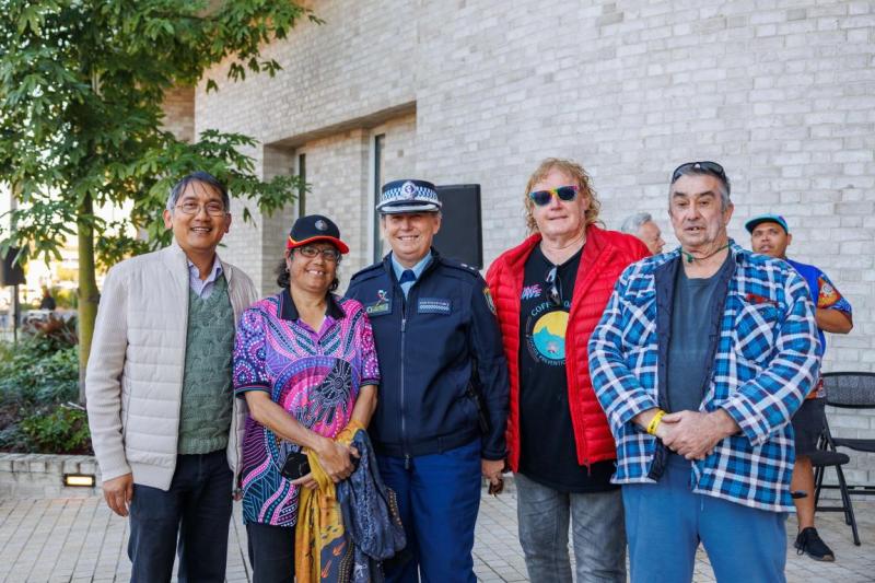 A group stand in front of a building