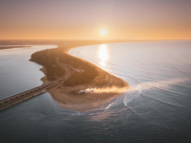 low land over the ocean in a sun rise