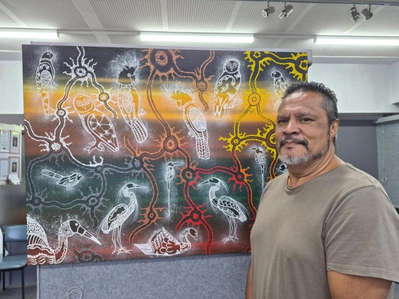 A man beside his artwork